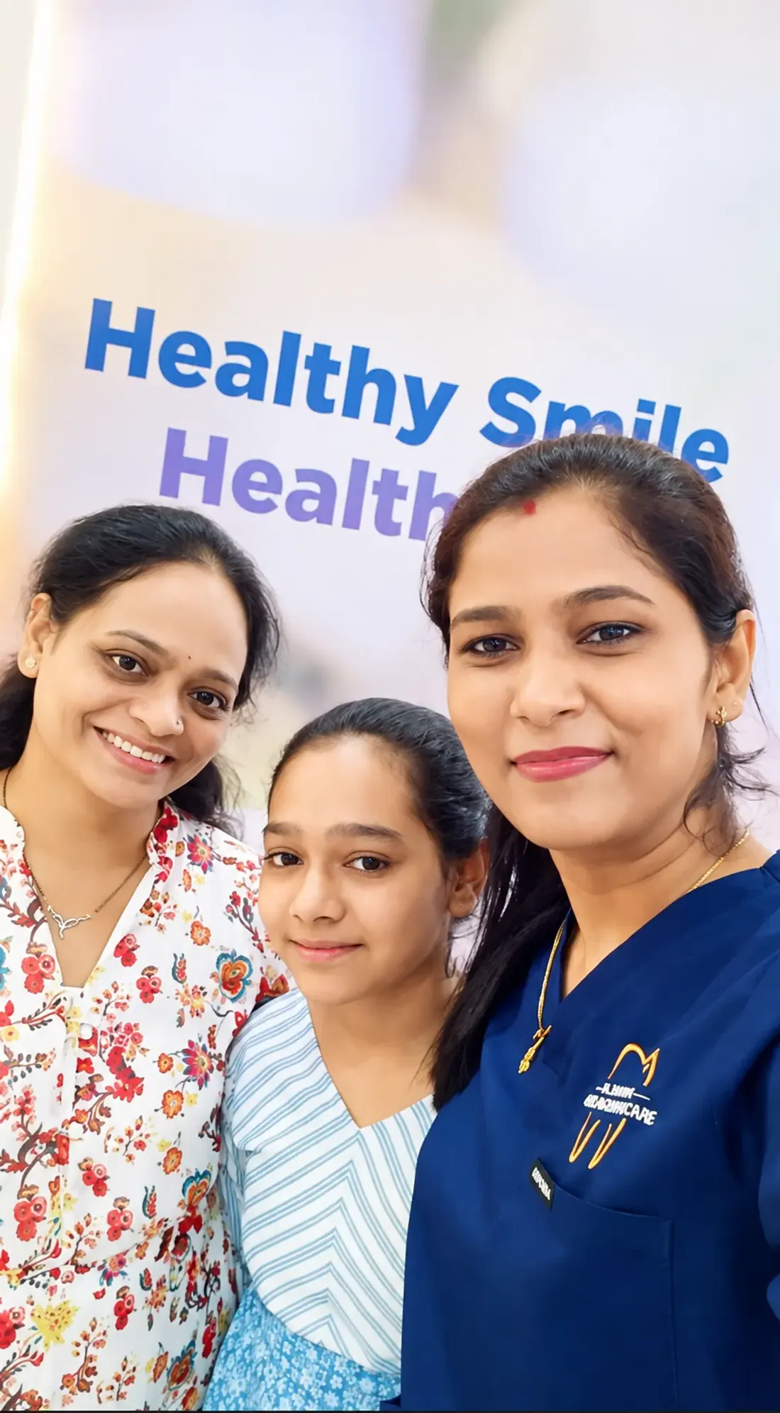 Dr. Supriya Holkar taking a selfie with a young patient and her mother at the clinic