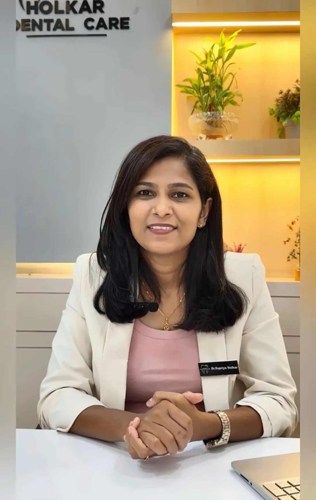 Dr. Supriya Holkar seated at her desk at the clinic